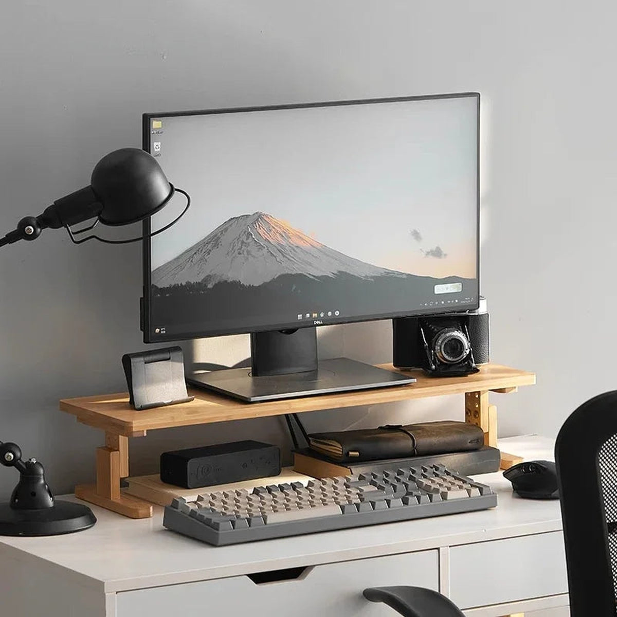 DECK bamboo monitor riser on a white desk