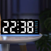 NEON clock on a side table at night
