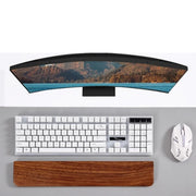 PALM walnut wrist rest in front of a white keyboard