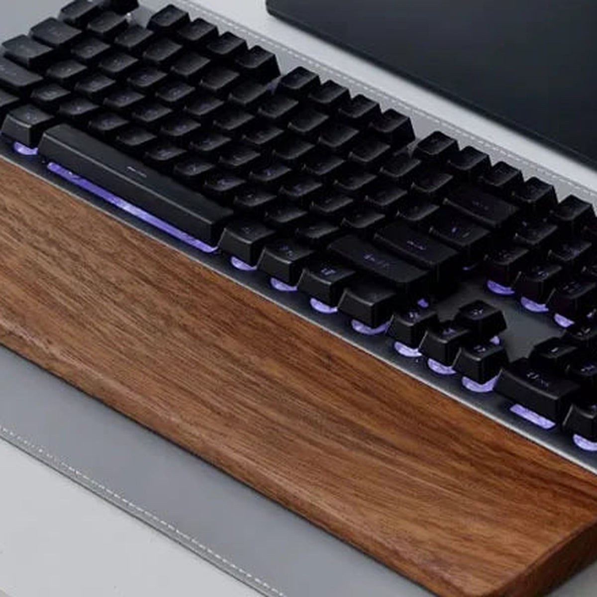 PALM walnut wrist rest under a backlit keyboard