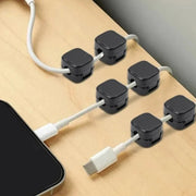 SNAP clips holding cables on a desk edge