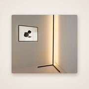 BEAM RGB corner floor lamp glowing warm white in a room corner