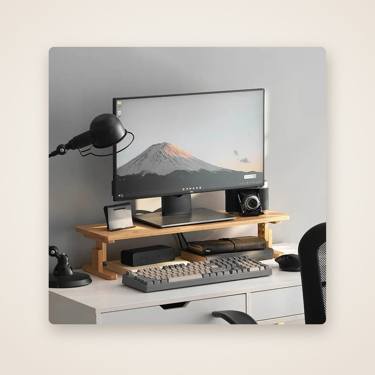 DECK bamboo monitor riser on a white desk