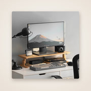DECK bamboo monitor riser on a white desk