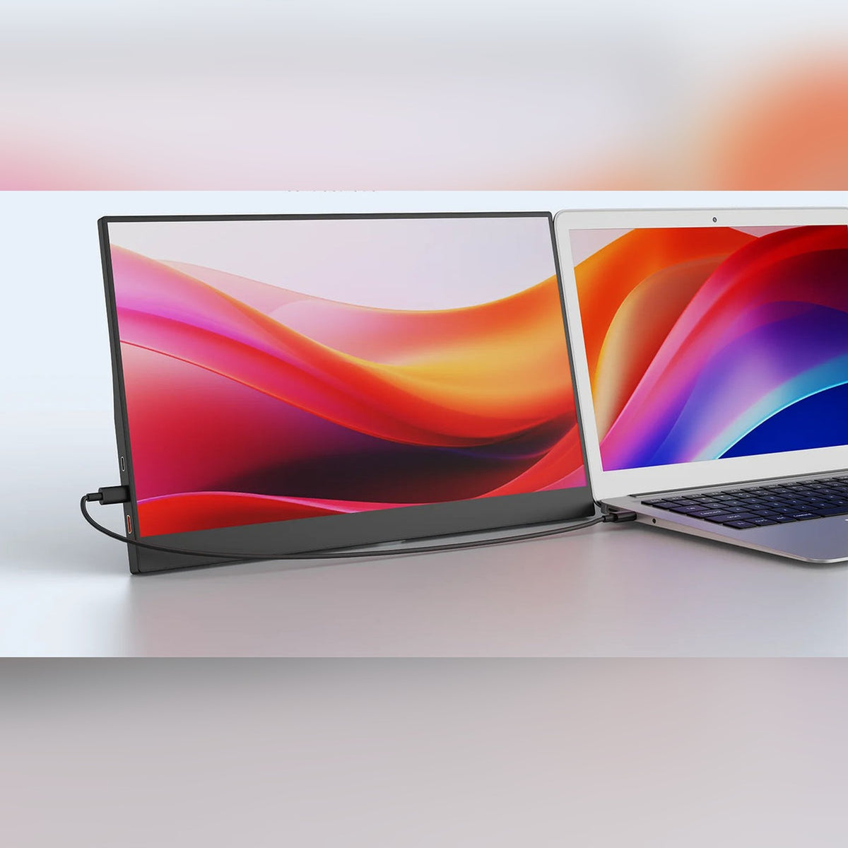 TWIN portable monitor next to a laptop